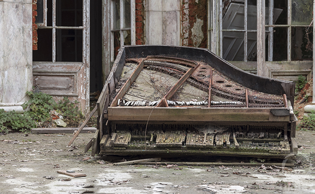 piano in patio in abandoned palace in poland