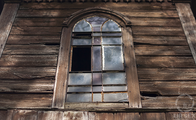 the broken window in the wooden building